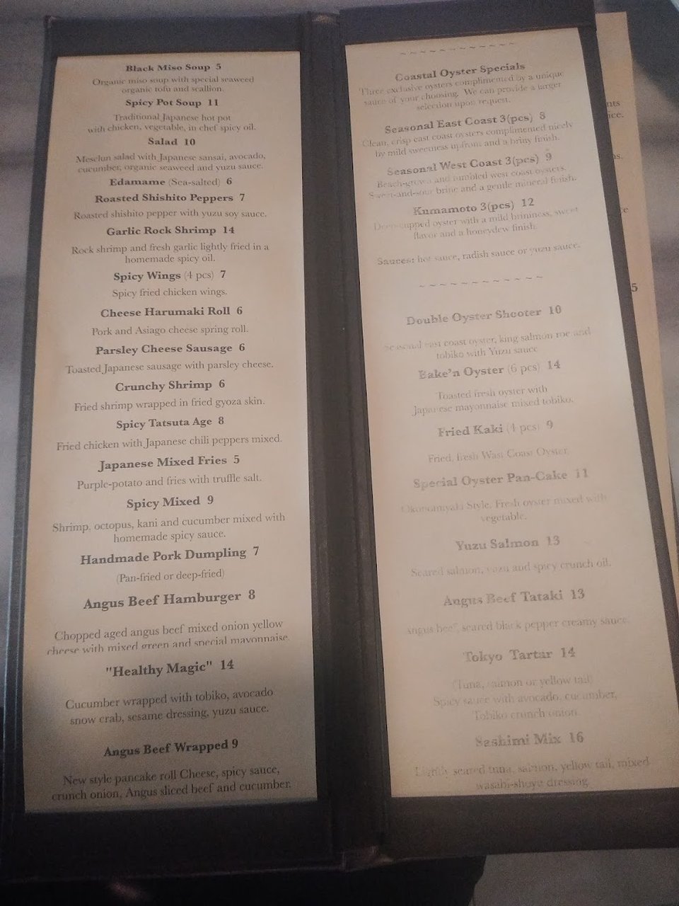 Cocktails and sake listed on a restaurant menu.